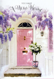 This serene doorway scene feels like a gentle exhale at the end of moving day in Wandsworth, captured in the soft glow of late afternoon. A pale pink front door, freshly painted and gently luminous, serves as the warm focal point, its tone mirrored in the muted shutter and the ribbon tied at the base of a nearby flower bucket. The surrounding walls are white and subtly textured, catching the sun in a way that brightens the entrance without overpowering it, reminiscent of the quietly elegant terraces near Wandsworth Town station or along the paths leading towards the River Thames. Above, wisteria trails down in long, romantic garlands of lavender blossoms, each cluster tumbling in loose, fragrant waves. The blooms arc around the top of the doorway and fall along the sides, creating a natural floral arch that feels both whimsical and carefully maintained. Nestled right by the threshold, a florist's grey metal bucket brims with white and cream roses, their petals layered and velvety, opened to that perfect point where they appear at their fullest. Sprigs of soft, green foliage peek out between the heads of the roses, lending nuance and gentle movement to the arrangement. A soft pink satin bow embraces the bucket, connecting the arrangement visually to the door and tying the whole palette together in harmonious pastels. Light filters through the wisteria and brushes the roses with gentle highlights, leaving faint, lace-like shadows on the step. Everything about the scene suggests tenderness and possibility-a floral greeting crafted to congratulate someone on their new home in Wandsworth and to bless the doorway with feelings of comfort, warmth, and the quiet thrill of starting over.